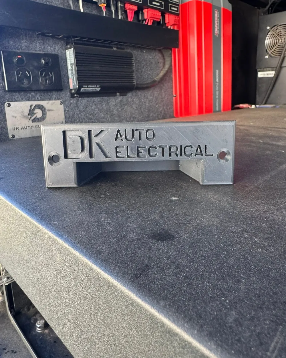 DK Auto Electrical badge on a canopy fitout