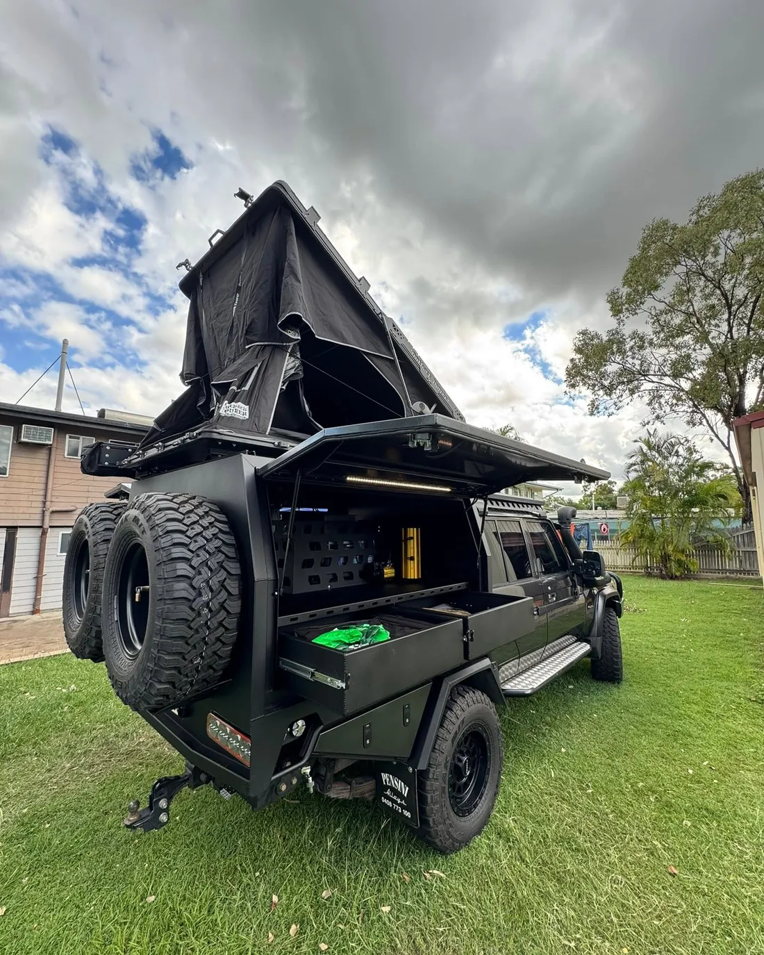 Black canopy build with rooftop tent and drawers open